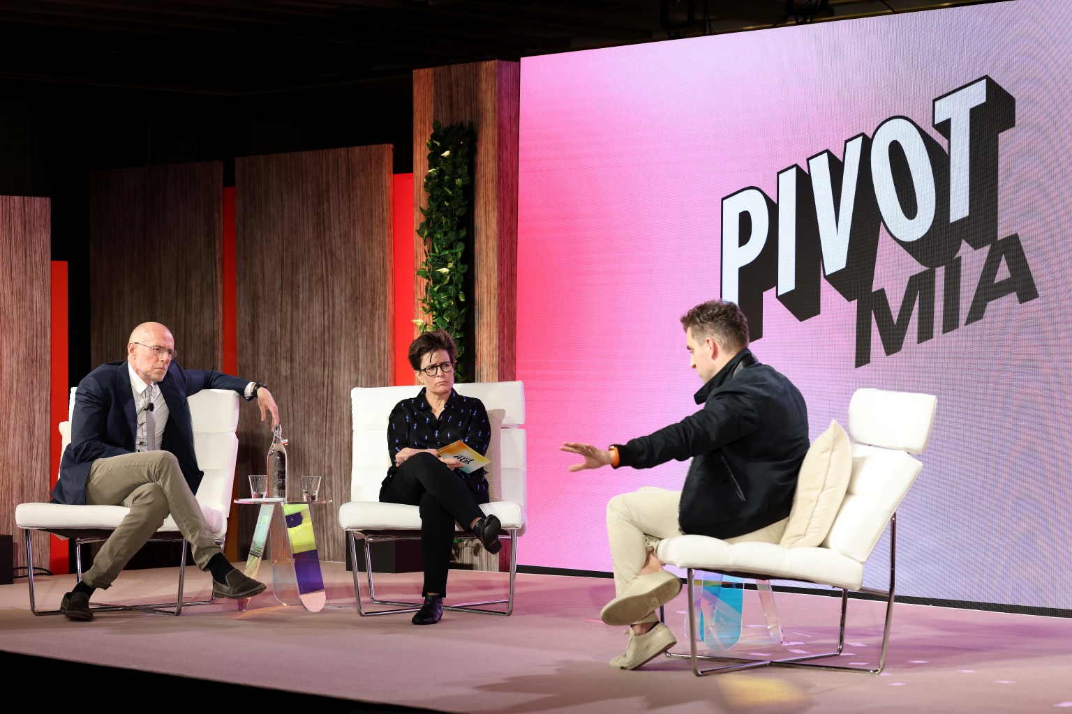 MIAMI, FLORIDA - FEBRUARY 16: Pivot and Host of the Prof G Show, Scott Galloway, Pivot and Editor-at-large for New York Magazine, Kara Swisher, and CEO of Airbnb, Brian Chesky speak on stage during Pivot MIA at 1 Hotel South Beach on February 16, 2022 in Miami, Florida. (Photo by Alexander Tamargo/Getty Images for Vox Media)